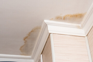 Neighbors have a water leak, water-damaged ceiling, close-up of a stain on the ceiling